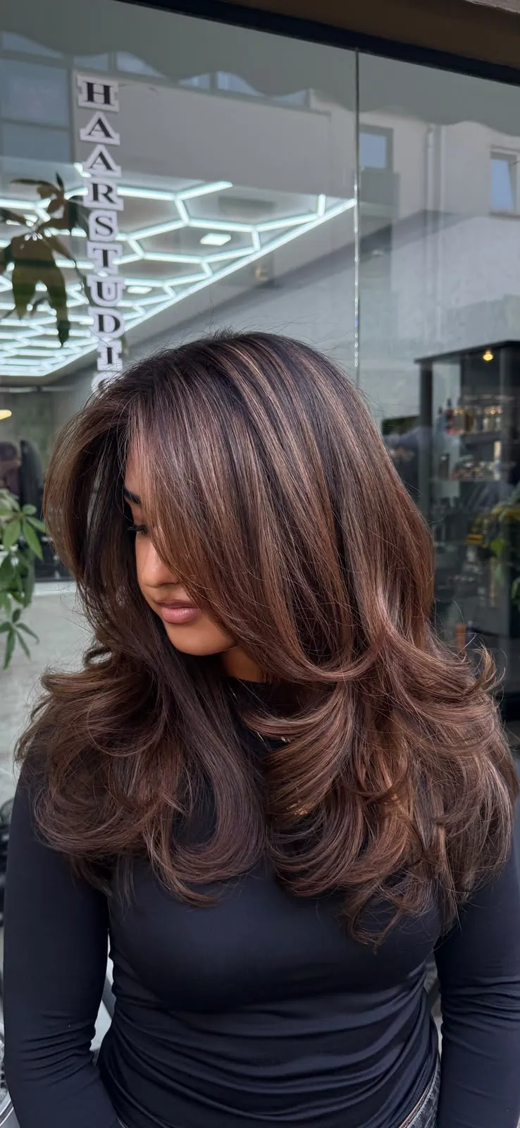 Butterfly Cut mit Karamell-Highlights auf dunkelbraunem Haar bei Haarstudio No. 8
